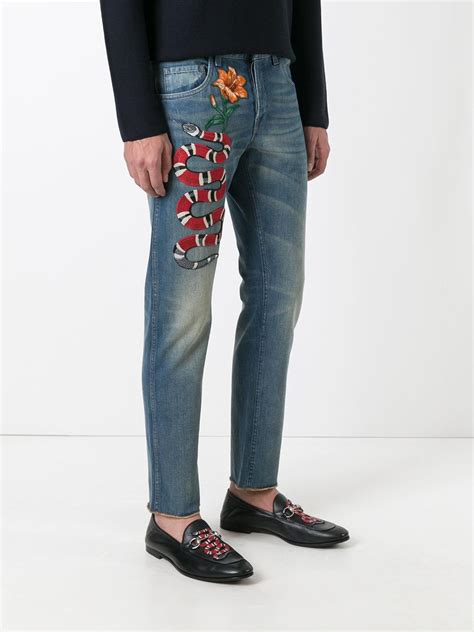 embroidered snake slim fit jeans.